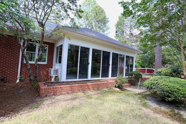 21 Birdie Dr, Whispering Pines, NC 28327 - rear view of property with brick siding, a lawn, roof with shingles, and a sunroom