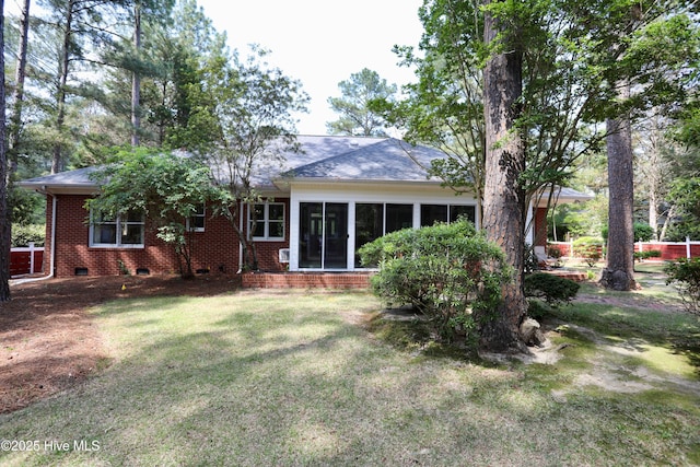 21 Birdie Dr, Whispering Pines, NC 28327 - rear view of property featuring a sunroom, a yard, brick siding, and crawl space