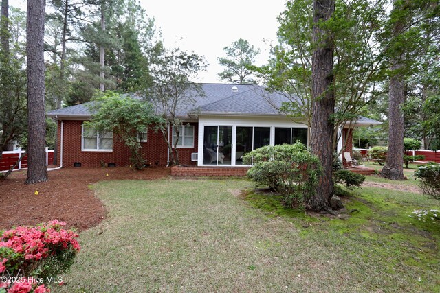 21 Birdie Dr, Whispering Pines, NC 28327 - rear view of house with a lawn, brick siding, crawl space, and a shingled roof