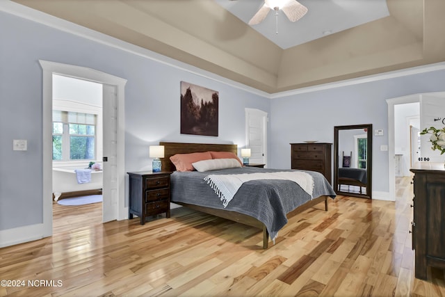 bedroom with light wood finished floors, a towering ceiling, baseboards, and a ceiling fan