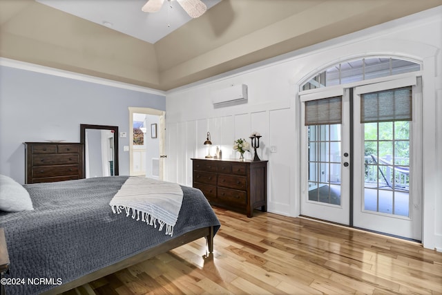 bedroom with wood finished floors, a ceiling fan, a towering ceiling, access to outside, and an AC wall unit