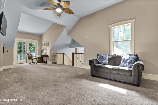 living room featuring a ceiling fan, lofted ceiling, french doors, baseboards, and carpet flooring
