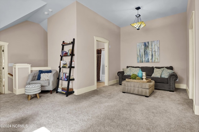 carpeted living room featuring vaulted ceiling and baseboards