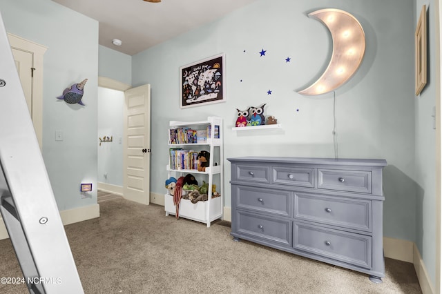 bedroom with light colored carpet and baseboards