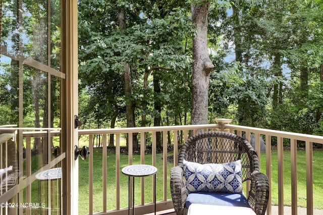 wooden deck with a lawn