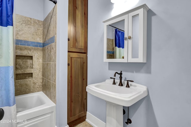 full bathroom featuring a sink and shower / bathtub combination with curtain