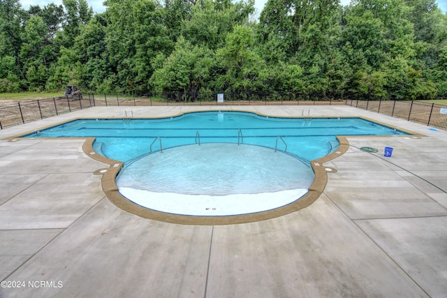 pool featuring a patio and fence