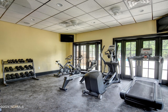 workout area featuring a paneled ceiling, baseboards, and visible vents