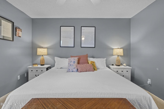 bedroom with baseboards, a textured ceiling, and ceiling fan