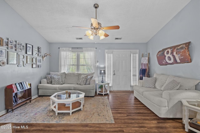 living area featuring wood finished floors, visible vents, and ceiling fan