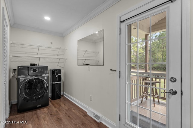 clothes washing area featuring crown molding, laundry area, dark wood finished floors, washer / clothes dryer, and visible vents