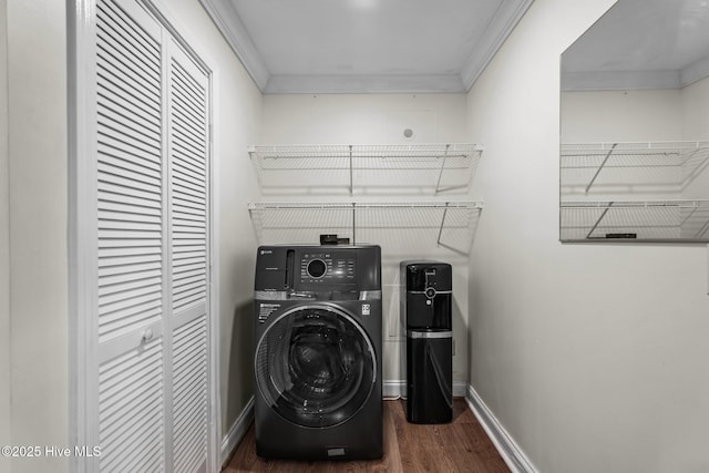 laundry room with wood finished floors, laundry area, ornamental molding, baseboards, and washer / clothes dryer