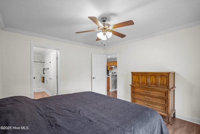 bedroom with baseboards, a ceiling fan, wood finished floors, ensuite bath, and ornamental molding