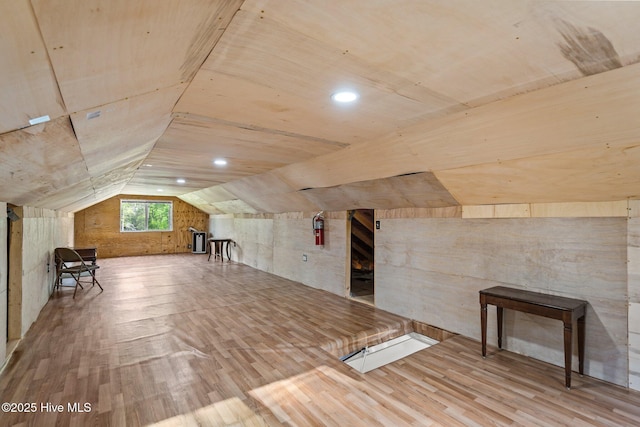 bonus room with lofted ceiling and wood finished floors