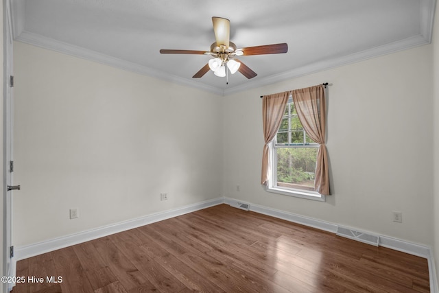 empty room with wood finished floors, baseboards, a ceiling fan, and visible vents