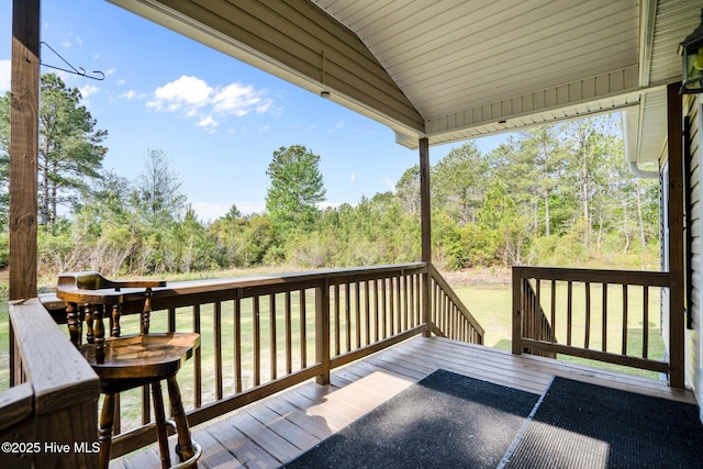 wooden terrace with a yard