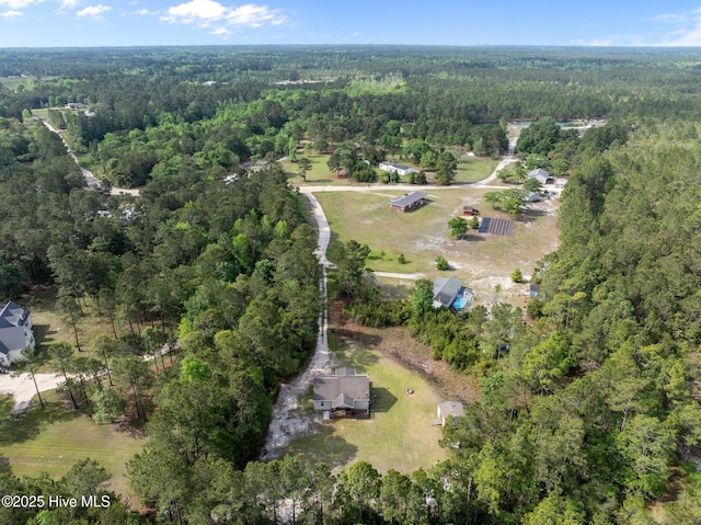 birds eye view of property with a forest view