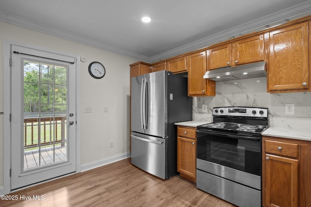 kitchen with stainless steel appliances, crown molding, brown cabinetry, and under cabinet range hood