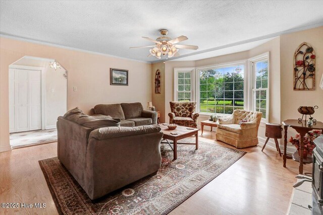 105 Harbor Dr, Washington, NC 27889 - living room with light wood finished floors, a textured ceiling, a ceiling fan, and arched walkways