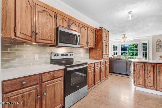 105 Harbor Dr, Washington, NC 27889 - kitchen with brown cabinets and stainless steel appliances