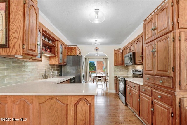 105 Harbor Dr, Washington, NC 27889 - kitchen with appliances with stainless steel finishes, light countertops, backsplash, a sink, and a peninsula