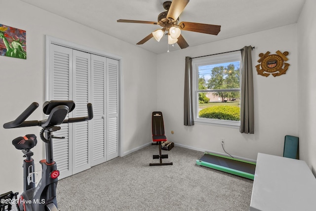 workout room featuring baseboards, carpet flooring, and a ceiling fan