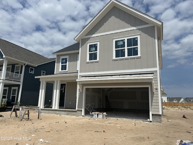 view of front of home featuring board and batten siding, an attached garage, and a porch