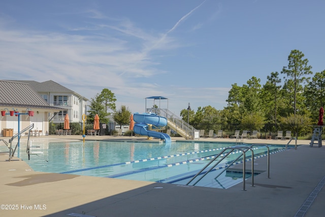 pool with fence, a water slide, and a patio area