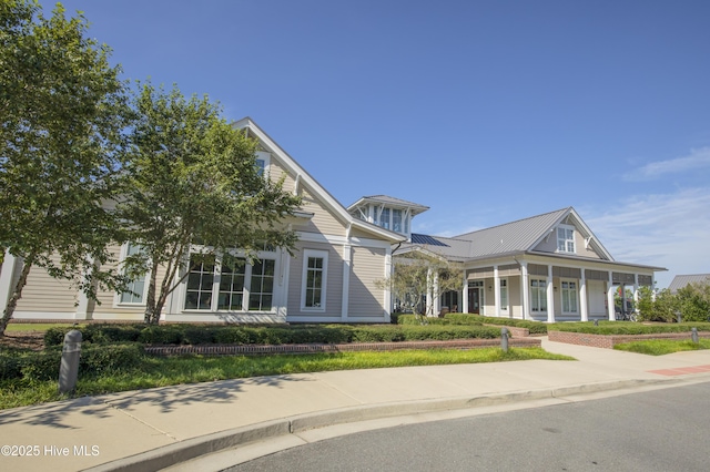 view of front of property featuring a porch, a standing seam roof, and metal roof
