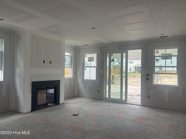 unfurnished living room with a glass covered fireplace