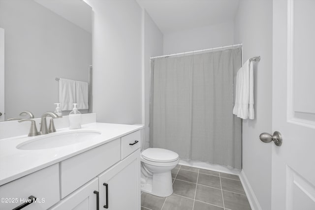bathroom featuring vanity, toilet, and tile patterned flooring