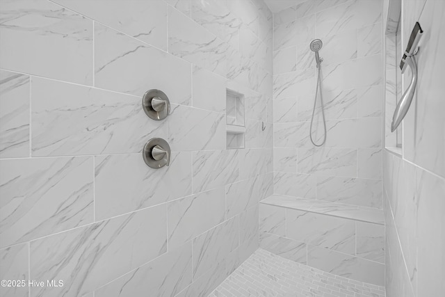 bathroom with tiled shower