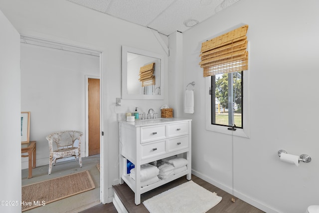 402 Dolphin St, Sunset Beach, NC 28468 - interior space with wood finished floors, a drop ceiling, vanity, and baseboards