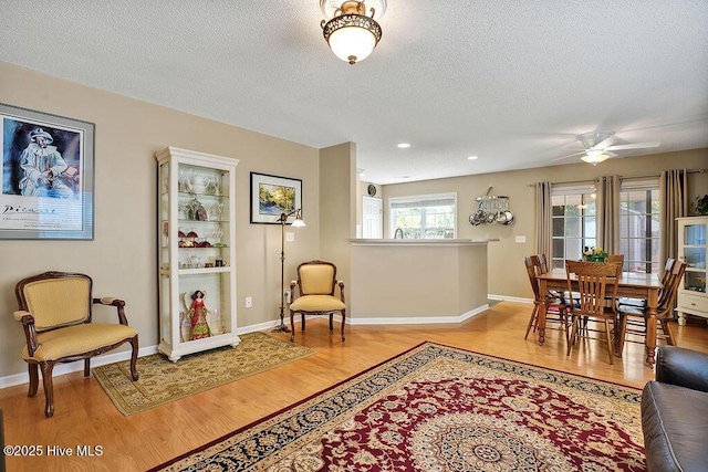 1005 Bellmark Ct, Leland, NC 28451 - living room featuring light wood-style floors, a textured ceiling, a ceiling fan, recessed lighting, and baseboards