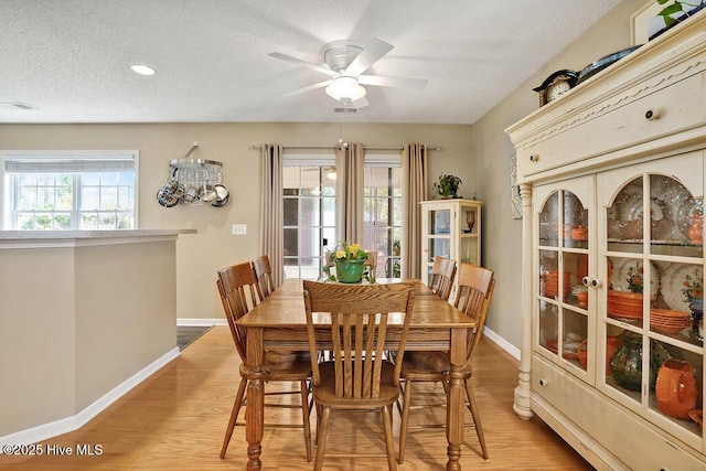 1005 Bellmark Ct, Leland, NC 28451 - dining area with baseboards, light wood-style floors, ceiling fan, a textured ceiling, and recessed lighting