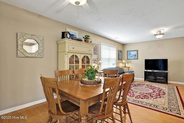 1005 Bellmark Ct, Leland, NC 28451 - dining room with light wood-style flooring, a textured ceiling, baseboards, and a ceiling fan