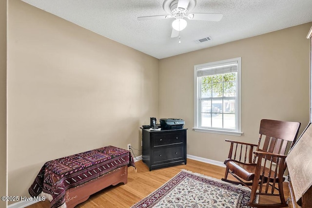 1005 Bellmark Ct, Leland, NC 28451 - bedroom featuring light wood-type flooring, a textured ceiling, baseboards, and a ceiling fan