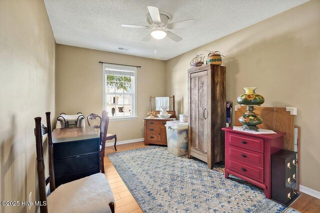 1005 Bellmark Ct, Leland, NC 28451 - office featuring ceiling fan, a textured ceiling, baseboards, and wood finished floors