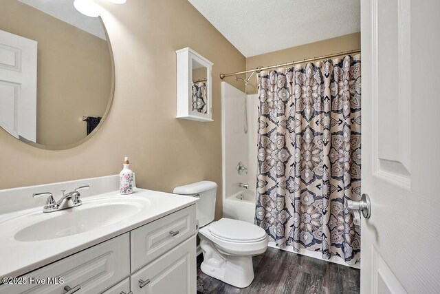 1005 Bellmark Ct, Leland, NC 28451 - full bathroom featuring vanity, toilet, shower / bathtub combination with curtain, and wood finished floors
