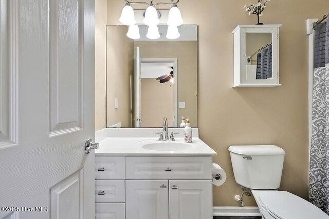 1005 Bellmark Ct, Leland, NC 28451 - full bathroom featuring toilet, a chandelier, and vanity