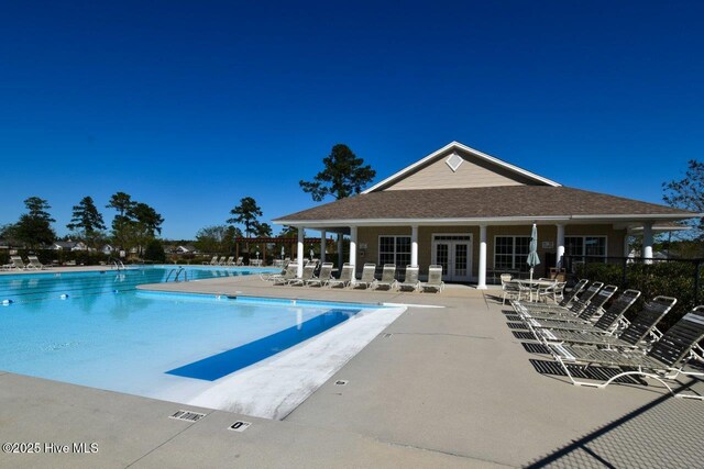1005 Bellmark Ct, Leland, NC 28451 - community pool with a patio area and french doors