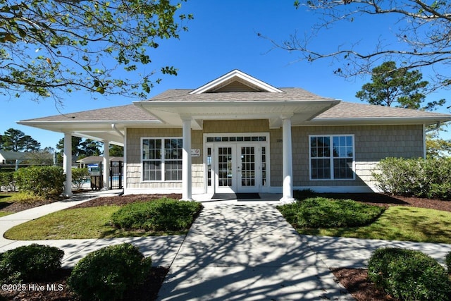 1005 Bellmark Ct, Leland, NC 28451 - view of exterior entry with french doors, covered porch, and roof with shingles