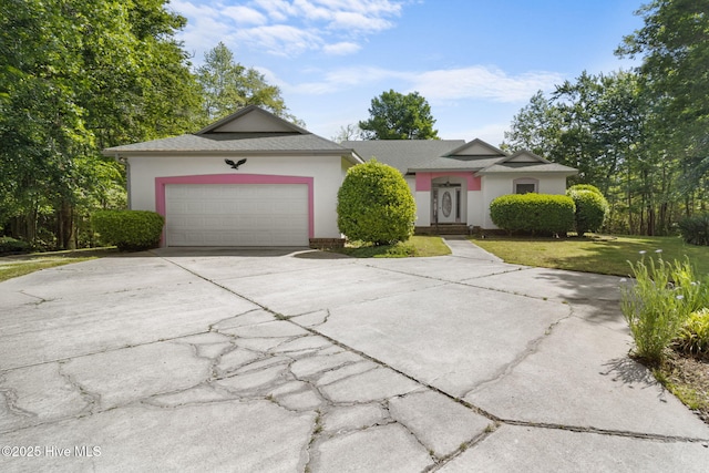 163 Middleton Dr, Hertford, NC 27944 - ranch-style house featuring a garage, stucco siding, driveway, and a front yard
