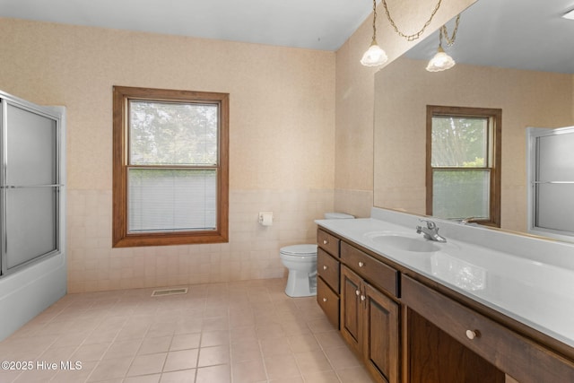 163 Middleton Dr, Hertford, NC 27944 - bathroom with tile walls, toilet, vanity, and plenty of natural light