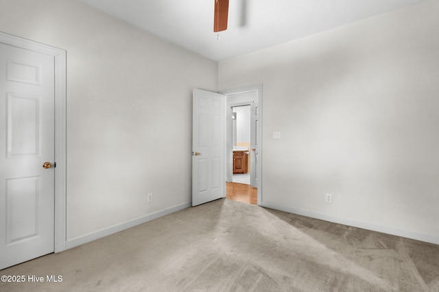 163 Middleton Dr, Hertford, NC 27944 - unfurnished bedroom with a ceiling fan, light colored carpet, and baseboards