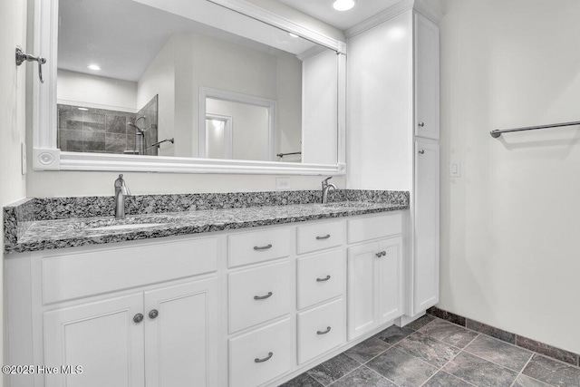 661 Jenoa Loop, Castle Hayne, NC 28429 - full bathroom with double vanity, baseboards, a tile shower, stone finish floors, and recessed lighting