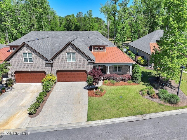 661 Jenoa Loop, Castle Hayne, NC 28429 - craftsman-style home with an attached garage, brick siding, a front lawn, concrete driveway, and a standing seam roof