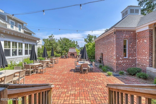 661 Jenoa Loop, Castle Hayne, NC 28429 - view of patio / terrace with a fireplace and outdoor dining space