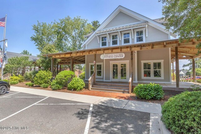 661 Jenoa Loop, Castle Hayne, NC 28429 - view of front facade with uncovered parking, french doors, and a porch