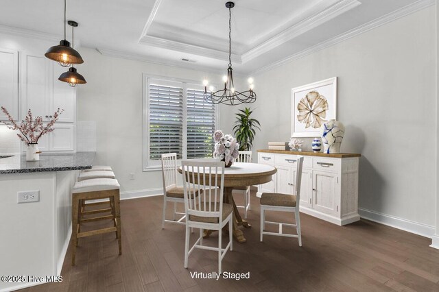 661 Jenoa Loop, Castle Hayne, NC 28429 - dining space with a tray ceiling, dark wood-type flooring, a chandelier, ornamental molding, and baseboards